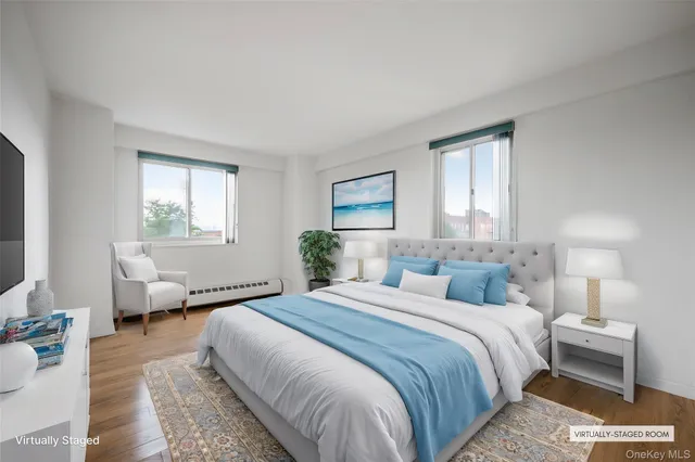 an empty room with wooden floor cabinet and windows