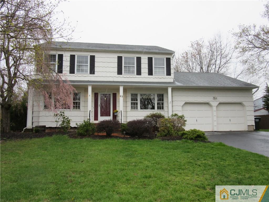 63 Royce Brook Road Hillsborough, NJ 08844 - Photo 1 of 25 a front view of a house with a garden and yard