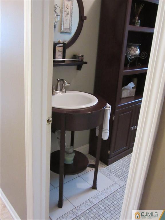 63 Royce Brook Road Hillsborough, NJ 08844 - Photo 20 of 25 a bathroom with a sink a mirror and a toilet