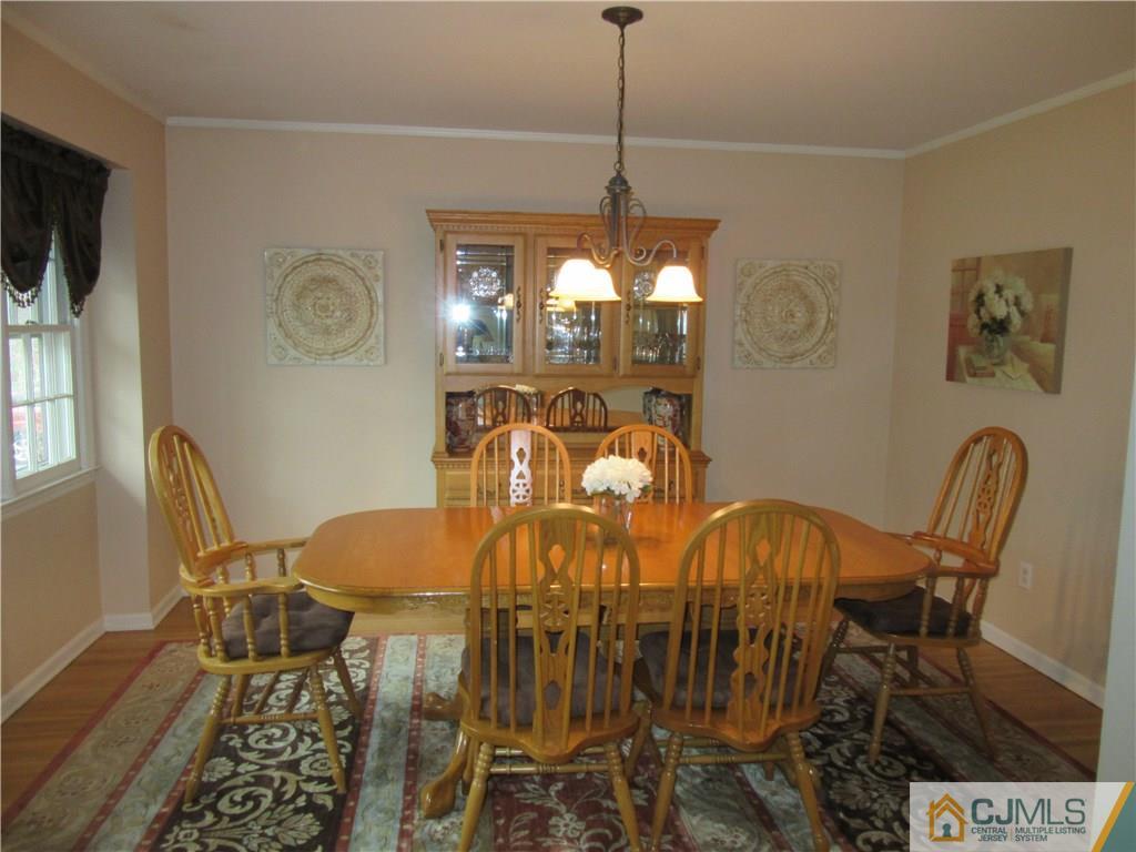 63 Royce Brook Road Hillsborough, NJ 08844 - Photo 4 of 25 a view of a dining room with furniture and chandelier
