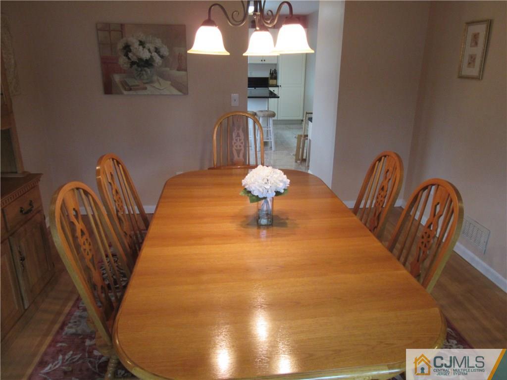 63 Royce Brook Road Hillsborough, NJ 08844 - Photo 5 of 25 a dining room with furniture and chandelier