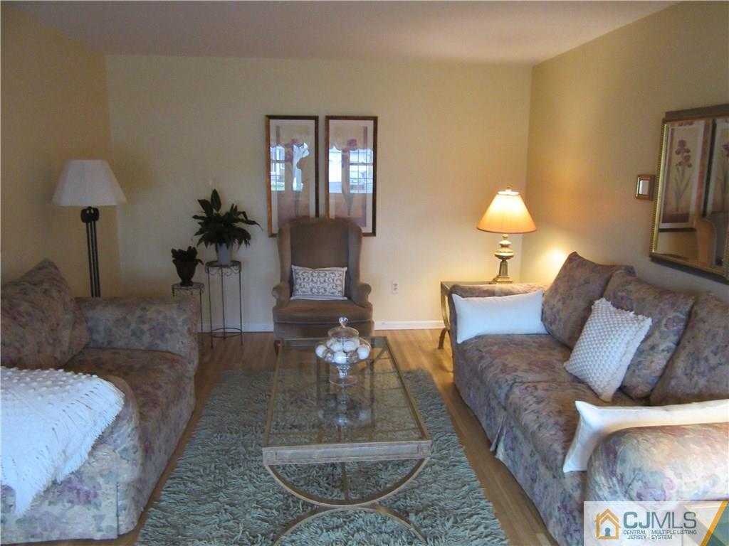 63 Royce Brook Road Hillsborough, NJ 08844 - Photo 7 of 25 a living room with furniture and a wooden floor
