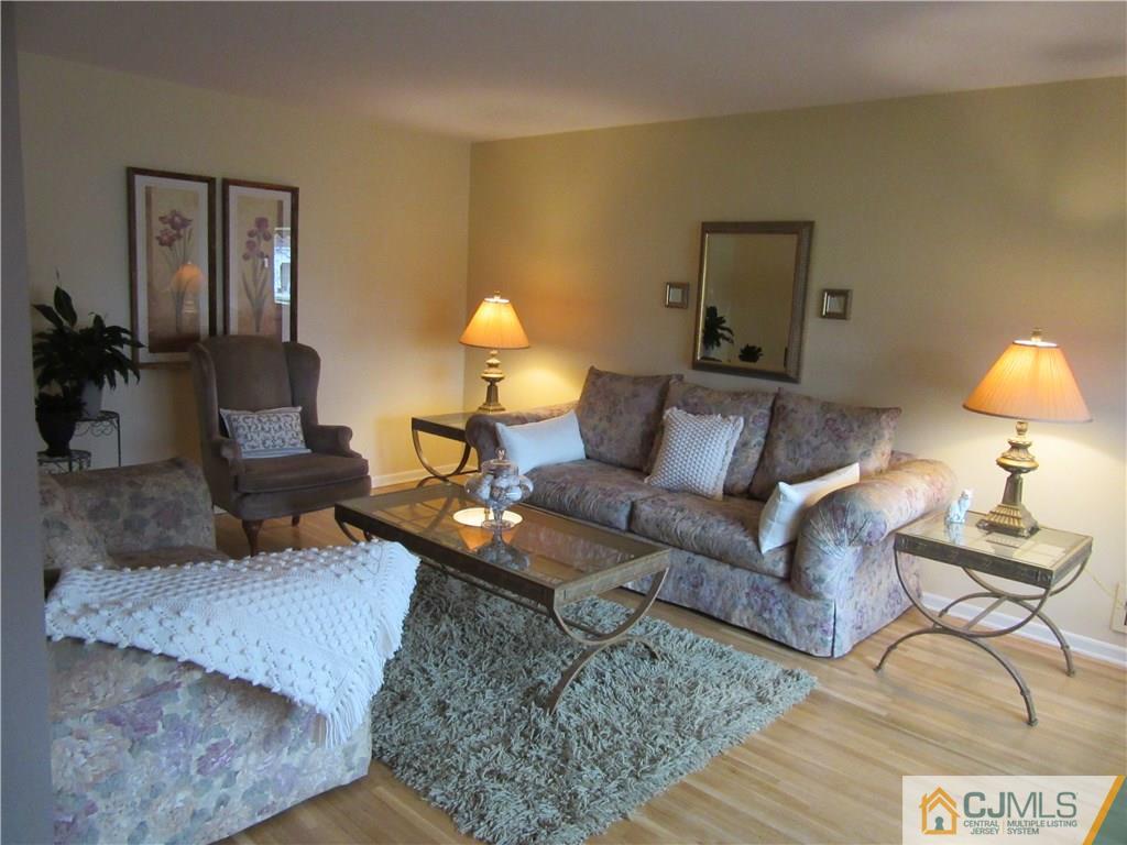 63 Royce Brook Road Hillsborough, NJ 08844 - Photo 8 of 25 a living room with furniture and a lamp