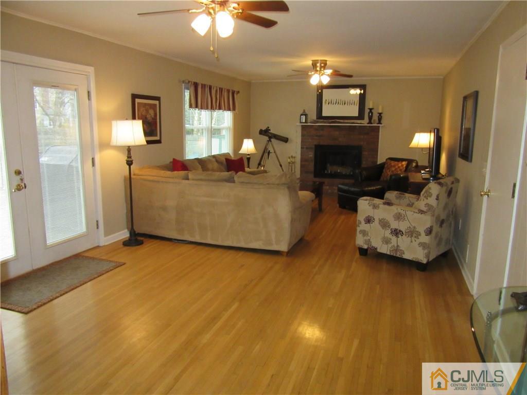 63 Royce Brook Road Hillsborough, NJ 08844 - Photo 9 of 25 a living room with furniture and a fireplace