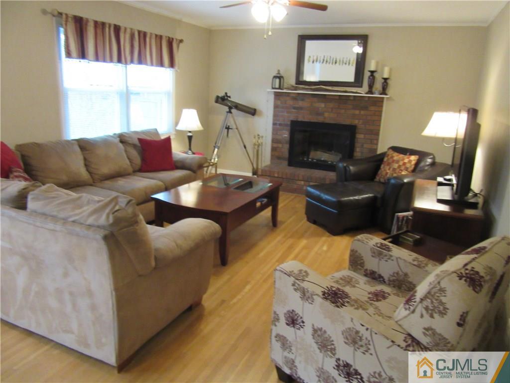 63 Royce Brook Road Hillsborough, NJ 08844 - Photo 10 of 25 a living room with furniture and a fireplace