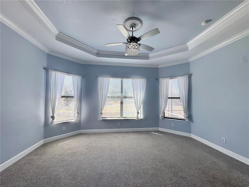12822 Del Corso Loop Bradenton, FL 34211 - Photo 14 of 58 a view of an empty room with chandelier fan and windows