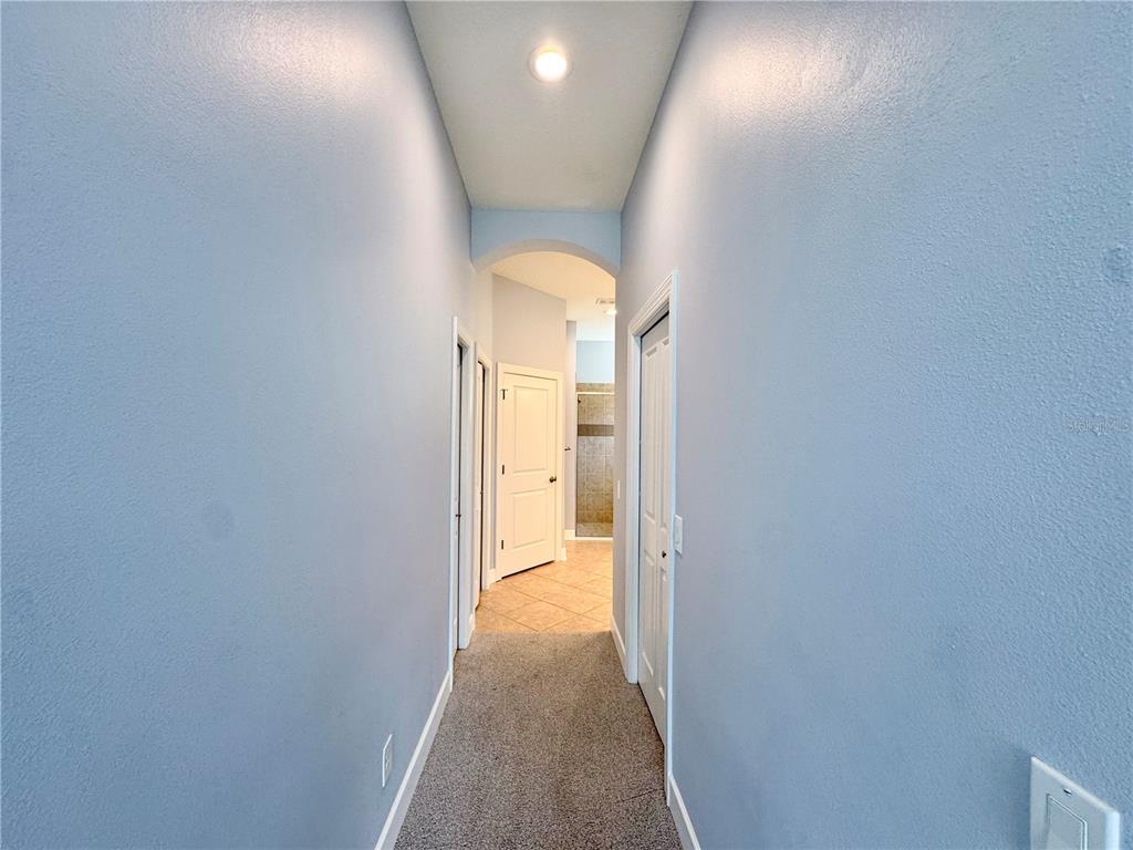 12822 Del Corso Loop Bradenton, FL 34211 - Photo 16 of 58 a view of a hallway with a dining room