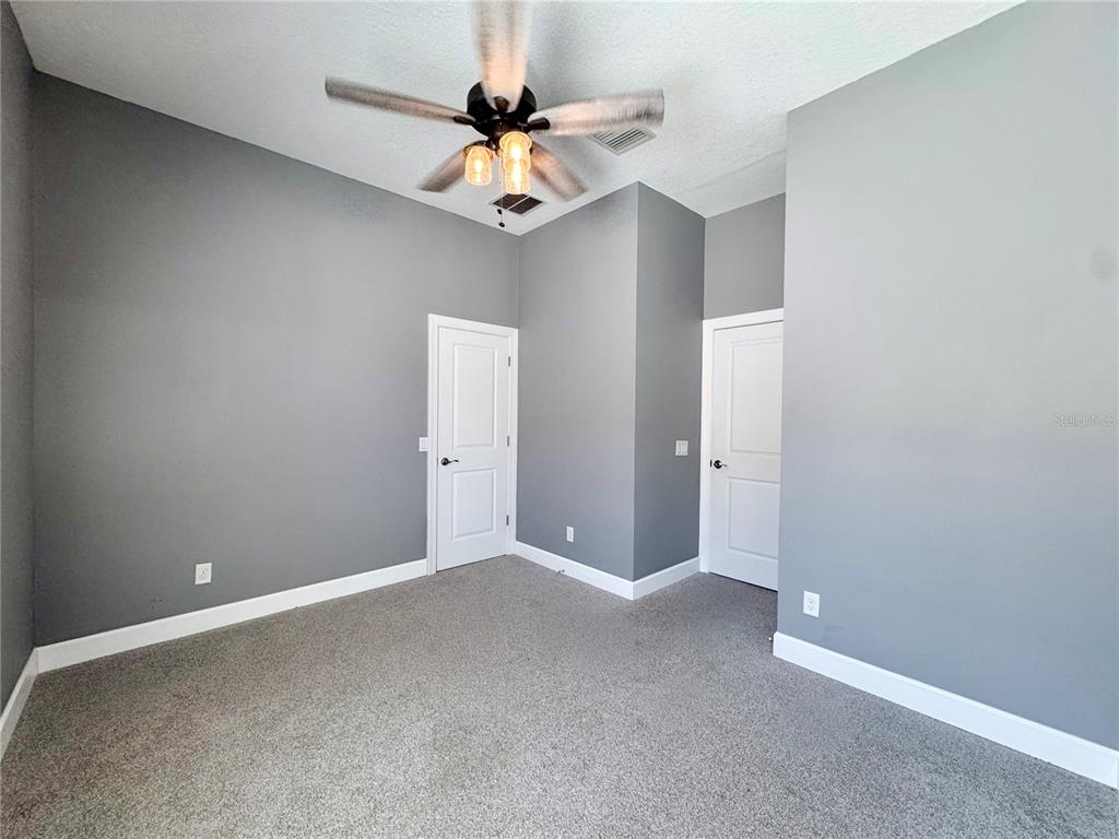 12822 Del Corso Loop Bradenton, FL 34211 - Photo 21 of 58 a view of an empty room with a chandelier fan