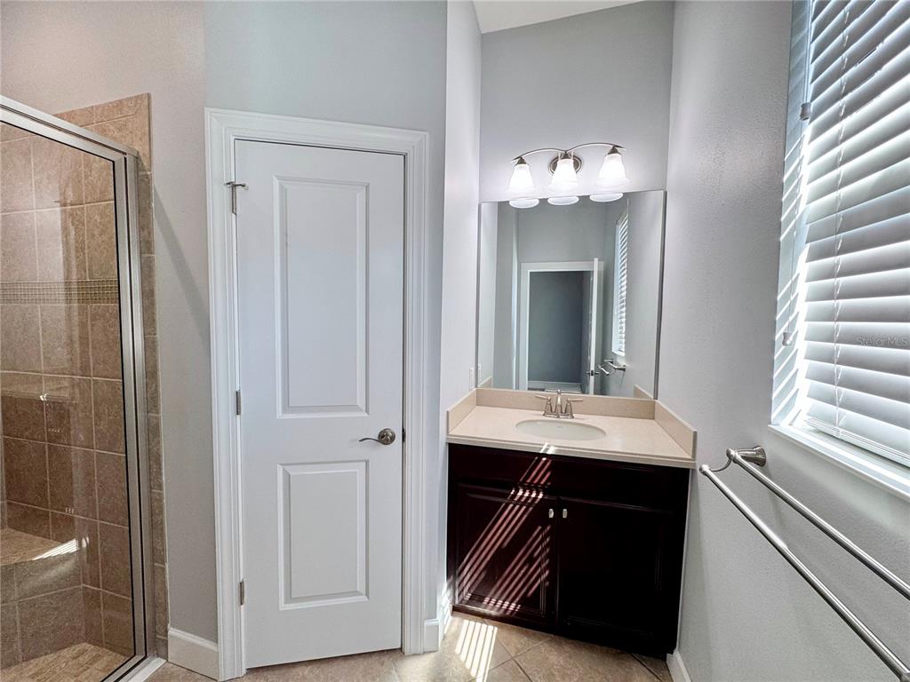 12822 Del Corso Loop Bradenton, FL 34211 - Photo 24 of 58 a bathroom with a sink vanity and a mirror