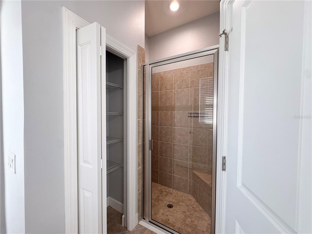 12822 Del Corso Loop Bradenton, FL 34211 - Photo 26 of 58 a bathroom with a glass shower door