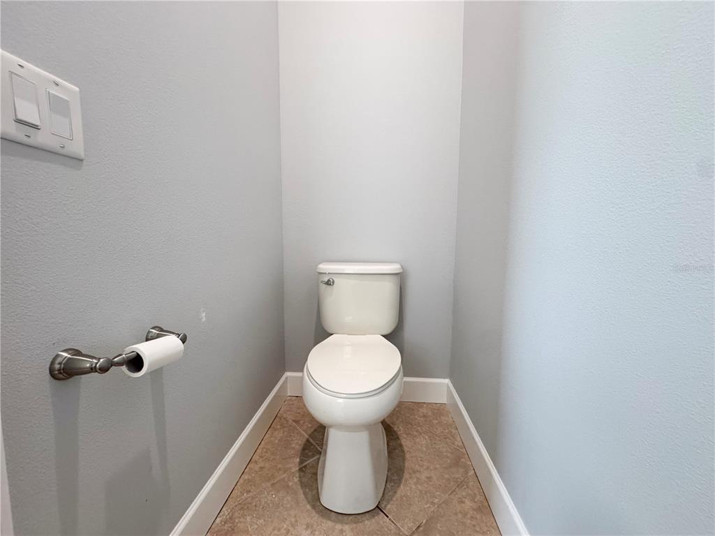 12822 Del Corso Loop Bradenton, FL 34211 - Photo 27 of 58 a white toilet sitting in a bathroom and a sink