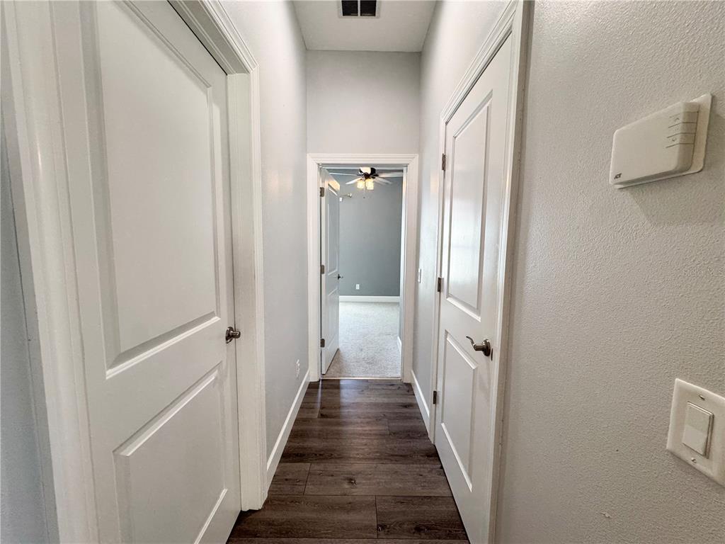 12822 Del Corso Loop Bradenton, FL 34211 - Photo 28 of 58 a view of a hallway with wooden floor and staircase