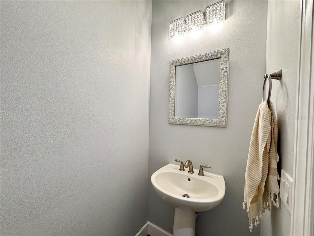 12822 Del Corso Loop Bradenton, FL 34211 - Photo 29 of 58 a bathroom with a sink a mirror and a shower