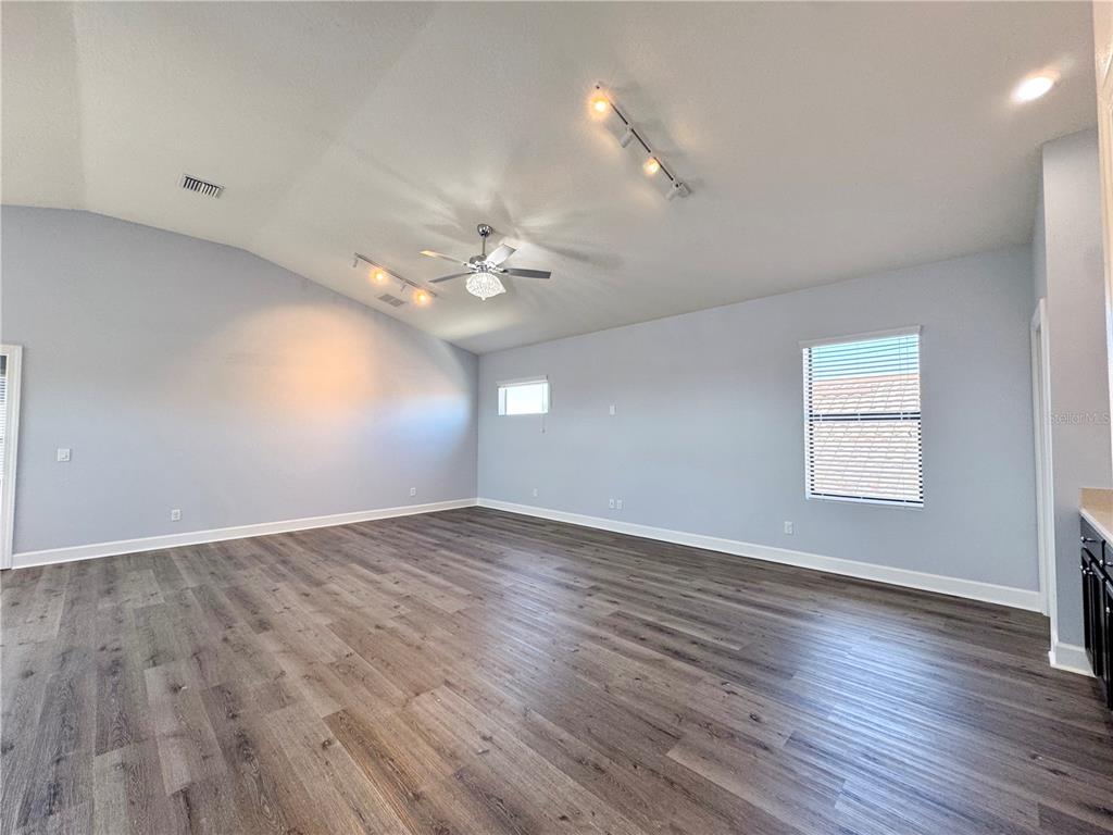 12822 Del Corso Loop Bradenton, FL 34211 - Photo 34 of 58 wooden floor in an empty room with a window