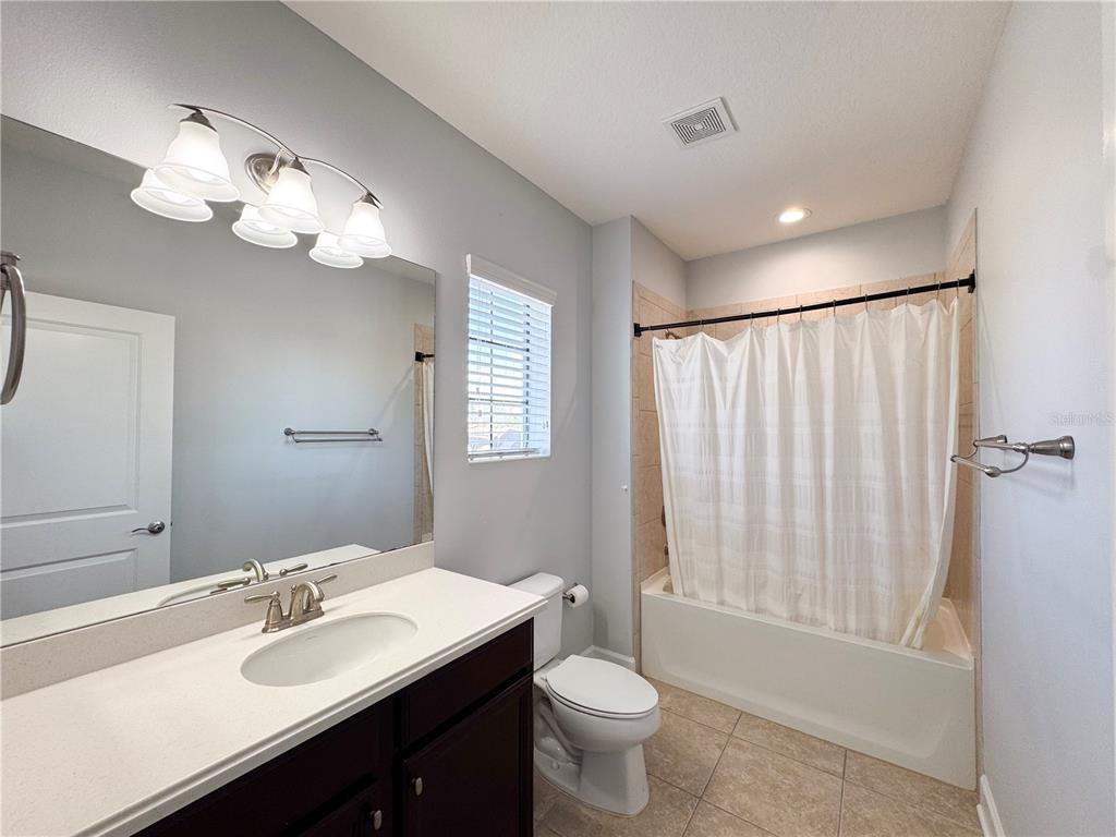 12822 Del Corso Loop Bradenton, FL 34211 - Photo 39 of 58 a bathroom with a double vanity sink mirror and toilet