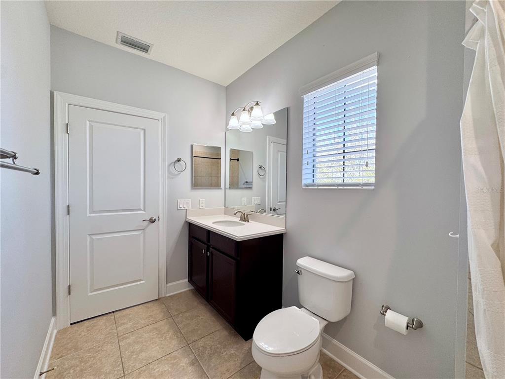 12822 Del Corso Loop Bradenton, FL 34211 - Photo 40 of 58 a bathroom with a sink vanity mirror and toilet