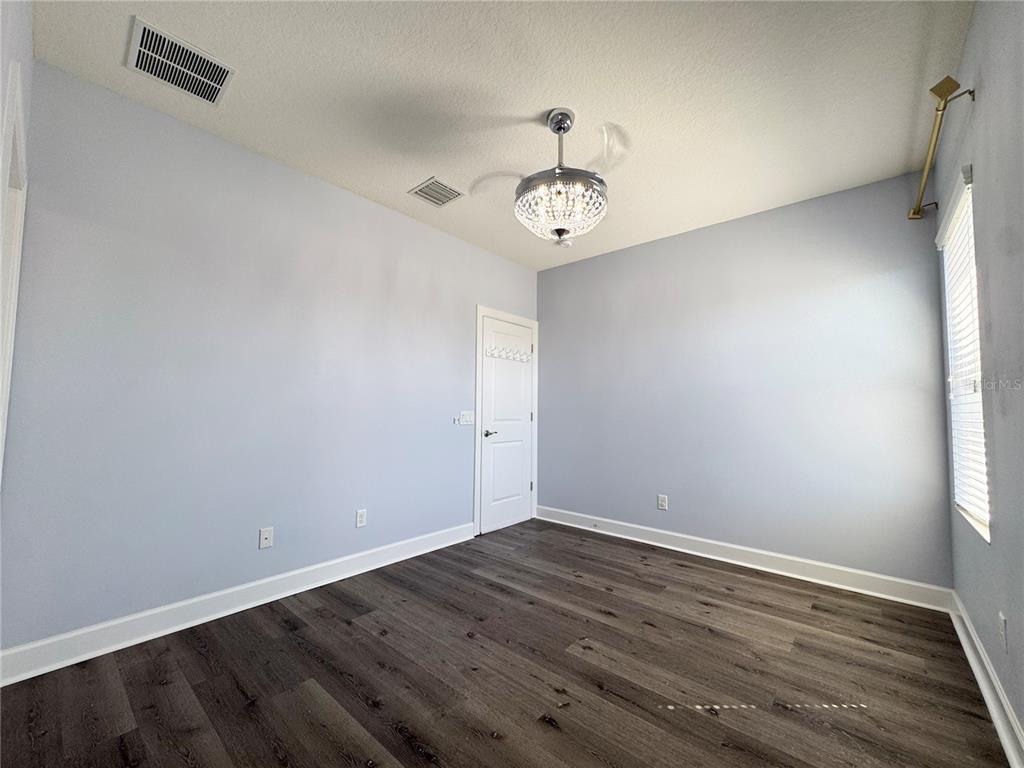 12822 Del Corso Loop Bradenton, FL 34211 - Photo 42 of 58 a view of a room with wooden floor and ceiling fan