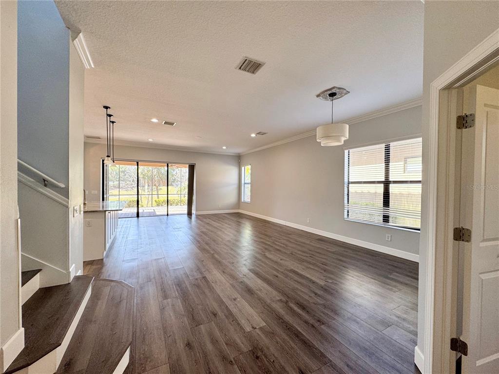 12822 Del Corso Loop Bradenton, FL 34211 - Photo 5 of 58 a view of empty room with wooden floor and fan