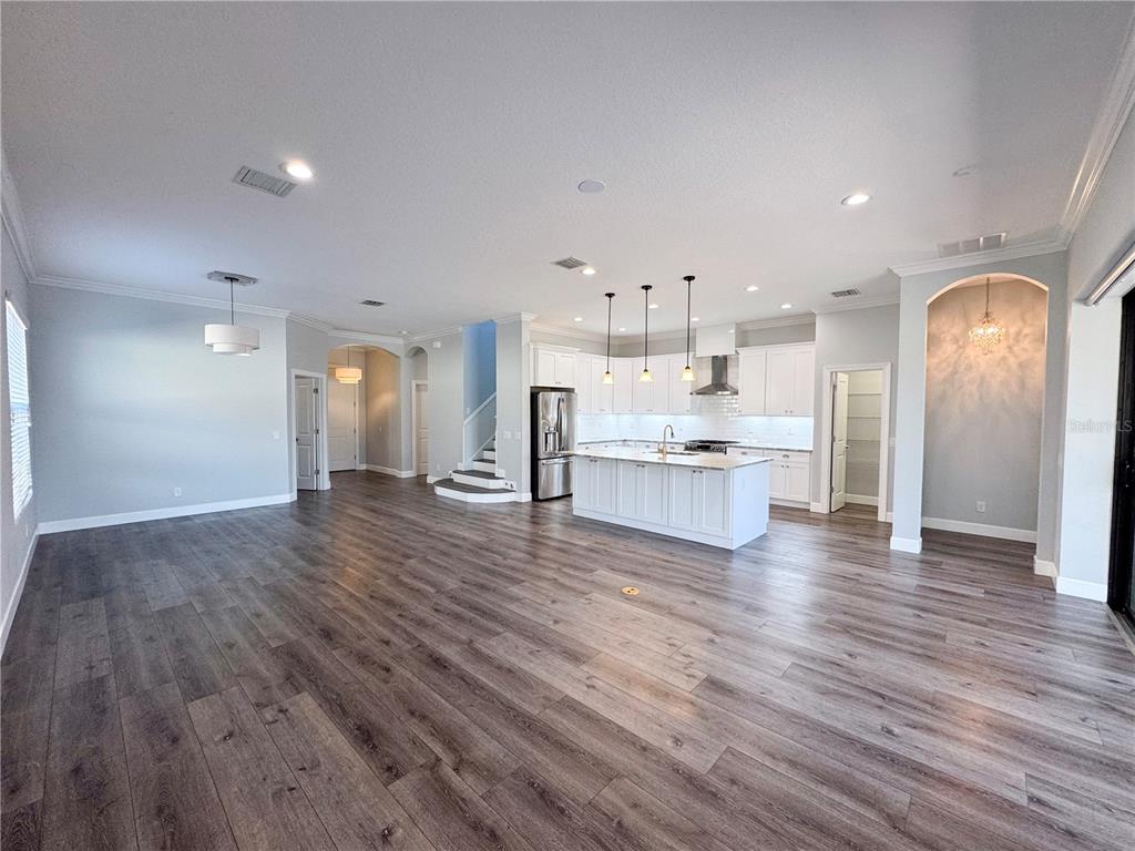 12822 Del Corso Loop Bradenton, FL 34211 - Photo 6 of 58 a view of kitchen with kitchen island wooden floors and stainless steel appliances