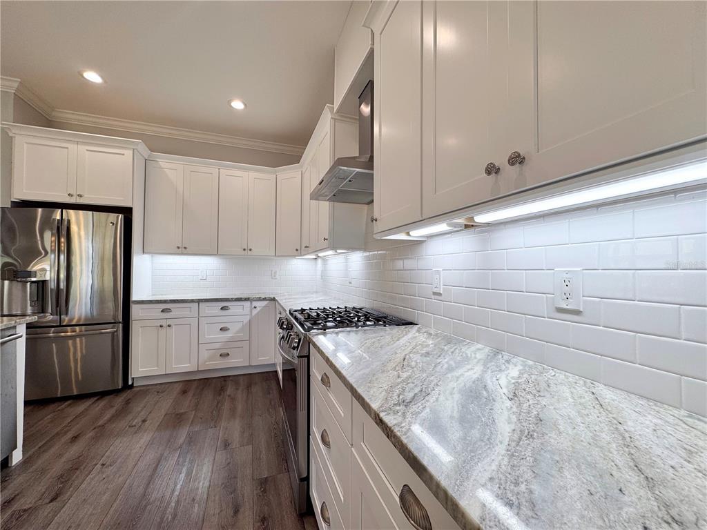 12822 Del Corso Loop Bradenton, FL 34211 - Photo 9 of 58 a kitchen with a stove a sink and a refrigerator