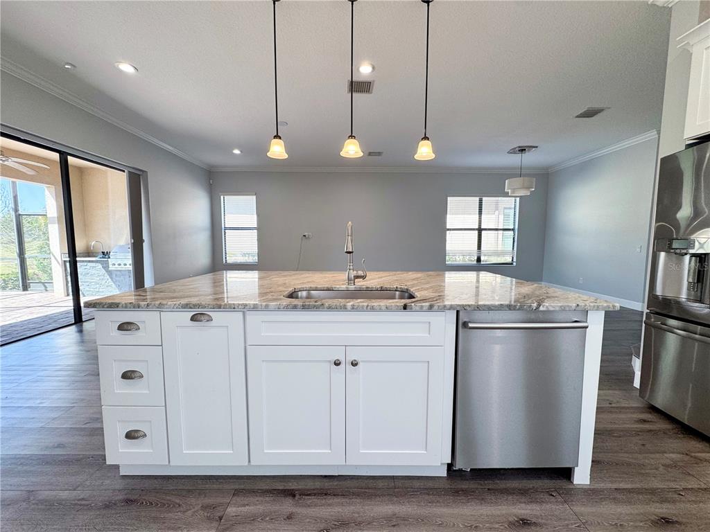12822 Del Corso Loop Bradenton, FL 34211 - Photo 10 of 58 a kitchen with stainless steel appliances granite countertop a sink a stove and a refrigerator