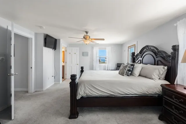 a bedroom with a bed and a mirror