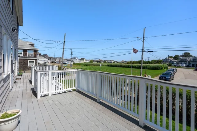 a view of a balcony with wooden floor