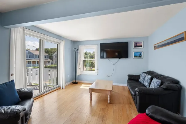 a bedroom with furniture and a flat screen tv
