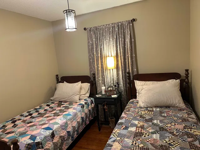 a bedroom with bed and window