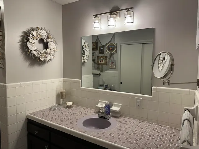 a bathroom with a sink vanity and a mirror