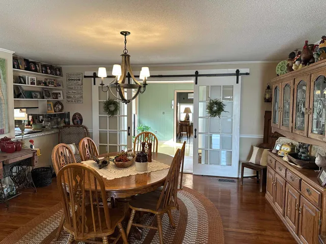 a view of a dining room with furniture and chandelier