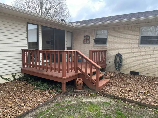 a view of a deck with a bench and wooden fence