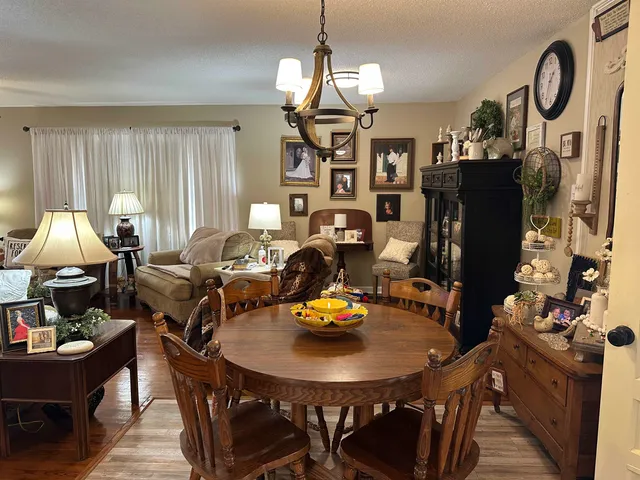 a view of a dining room with furniture and chandelier
