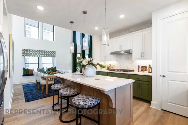 a kitchen with a dining table chairs stove refrigerator and cabinets