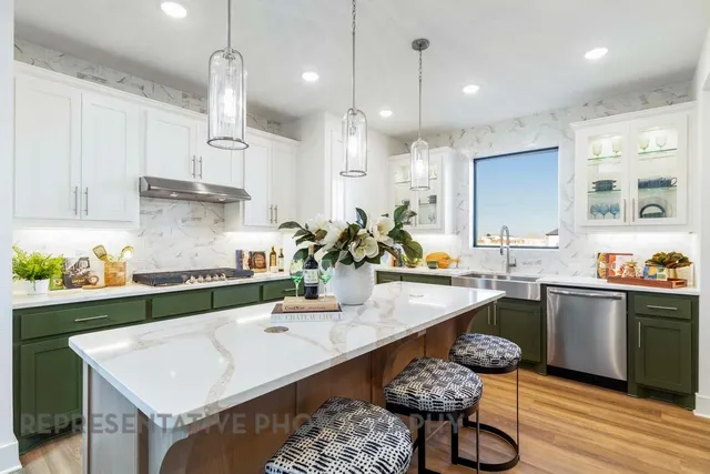 a kitchen with a sink a stove and chairs