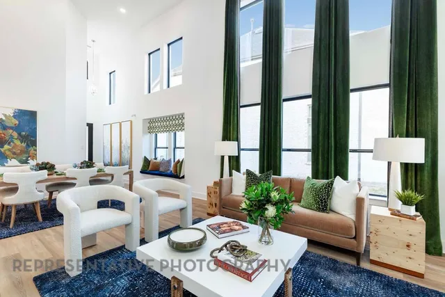 a living room with furniture fireplace and a large window