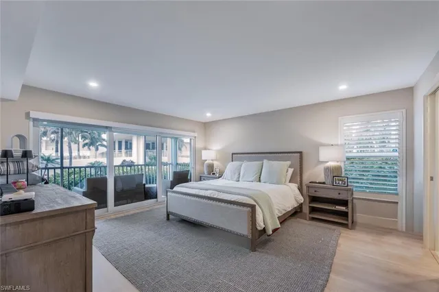 a spacious bedroom with a bed and a large window