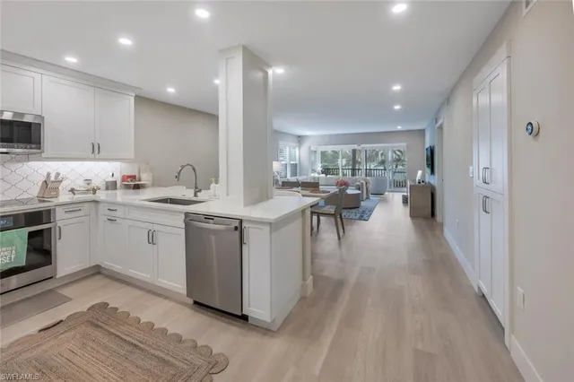 a kitchen with a sink appliances and cabinets