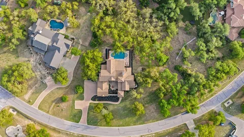 an aerial view of a house with a yard