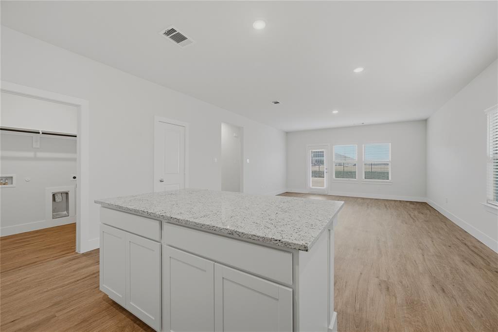 1346 Chisos Way Forney, TX 75126 - Photo 14 of 40 an empty room with wooden floor