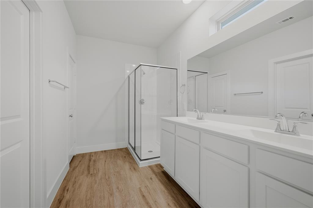 1346 Chisos Way Forney, TX 75126 - Photo 20 of 40 a bathroom with a double vanity sink and mirror