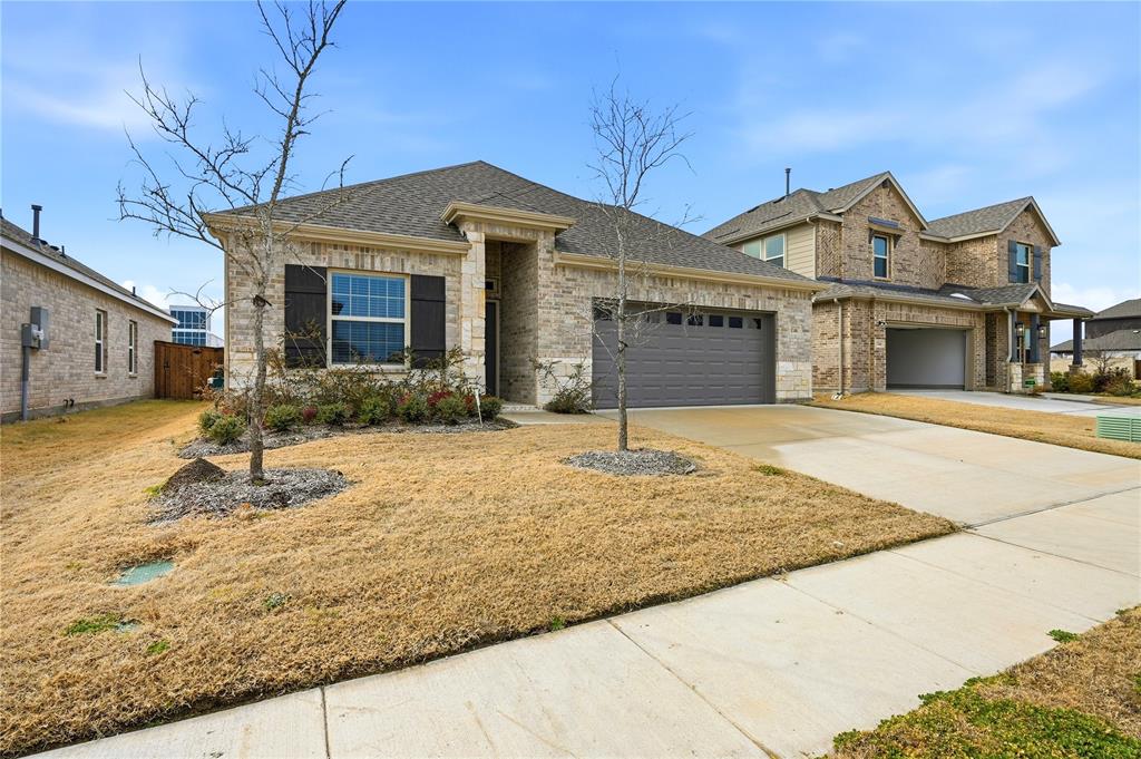 1346 Chisos Way Forney, TX 75126 - Photo 2 of 40 a front view of a house with garden