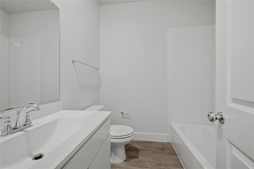 1346 Chisos Way Forney, TX 75126 - Photo 24 of 40 a bathroom with a sink a toilet and bathtub