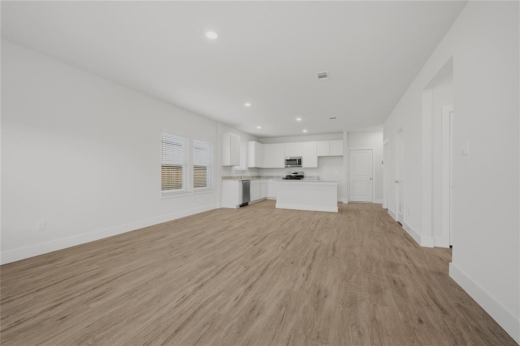 1346 Chisos Way Forney, TX 75126 - Photo 7 of 40 a view of a kitchen with a sink and wooden floor