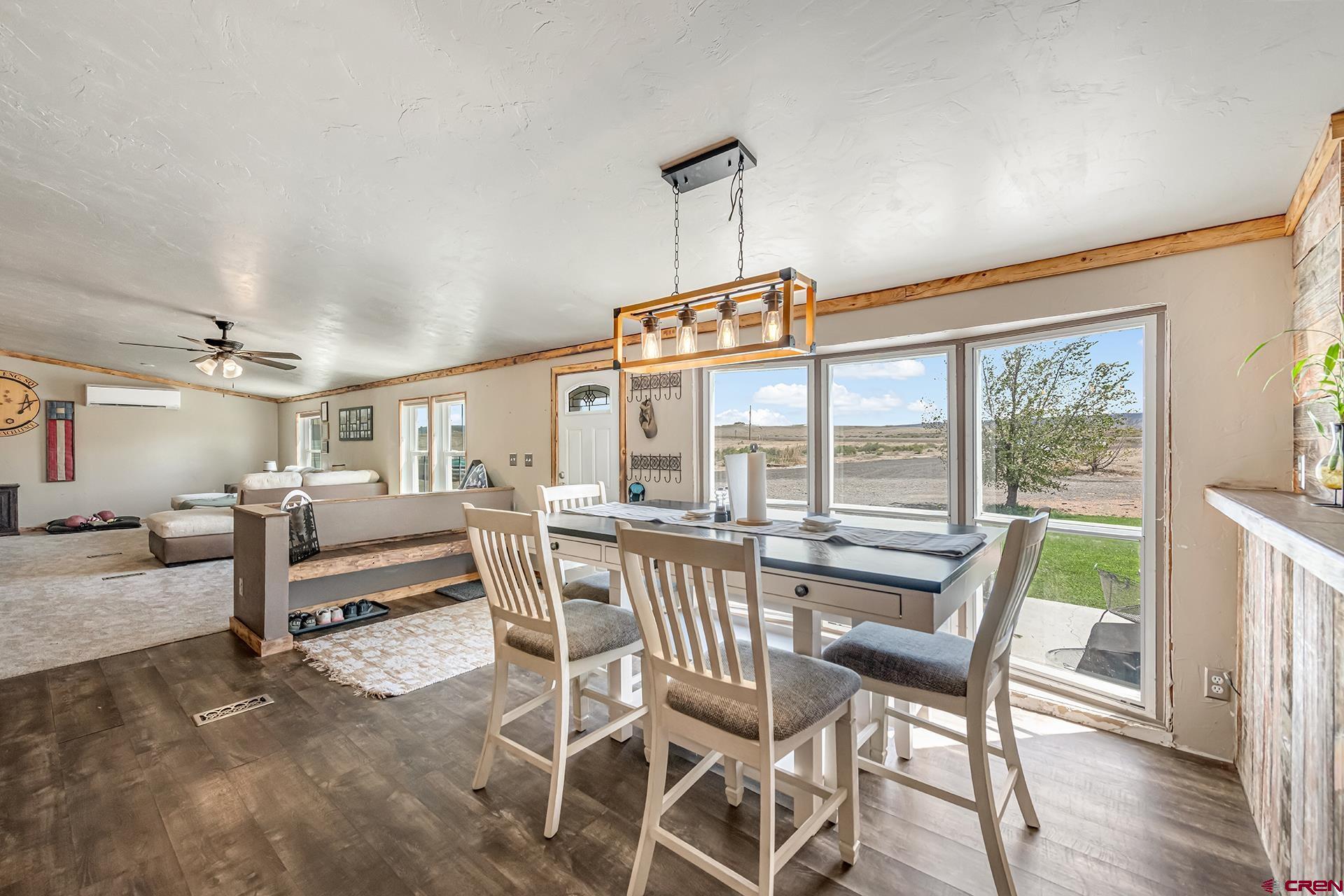 2787 2100th Road Delta, CO 81416 - Photo 11 of 40 a view of a dining room and livingroom with furniture wooden floor and a rug