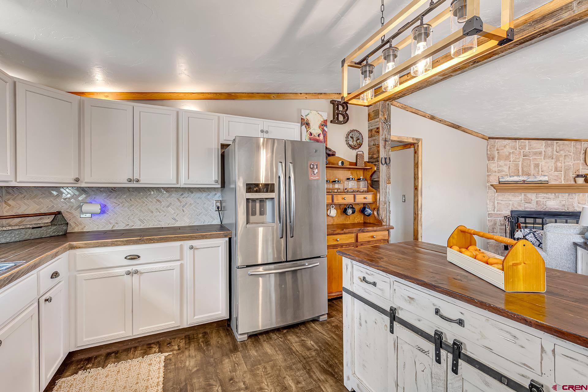 2787 2100th Road Delta, CO 81416 - Photo 14 of 40 a kitchen with stainless steel appliances white cabinets and a refrigerator