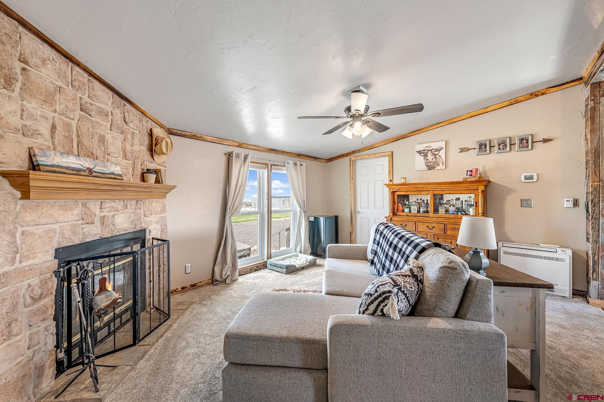 2787 2100th Road Delta, CO 81416 - Photo 18 of 40 a living room with furniture and a fireplace