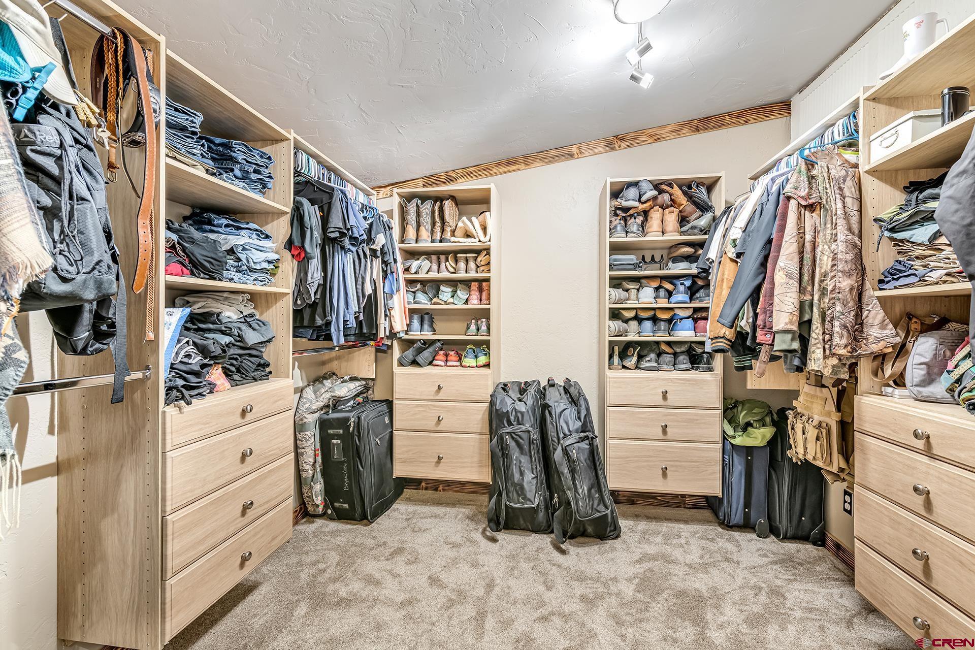 2787 2100th Road Delta, CO 81416 - Photo 24 of 40 a view of walk in closet with clothes and shoes