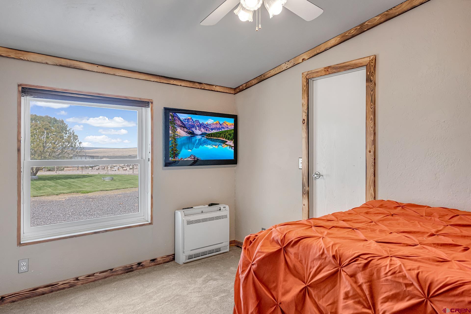 2787 2100th Road Delta, CO 81416 - Photo 25 of 40 a bedroom with a bed and a window