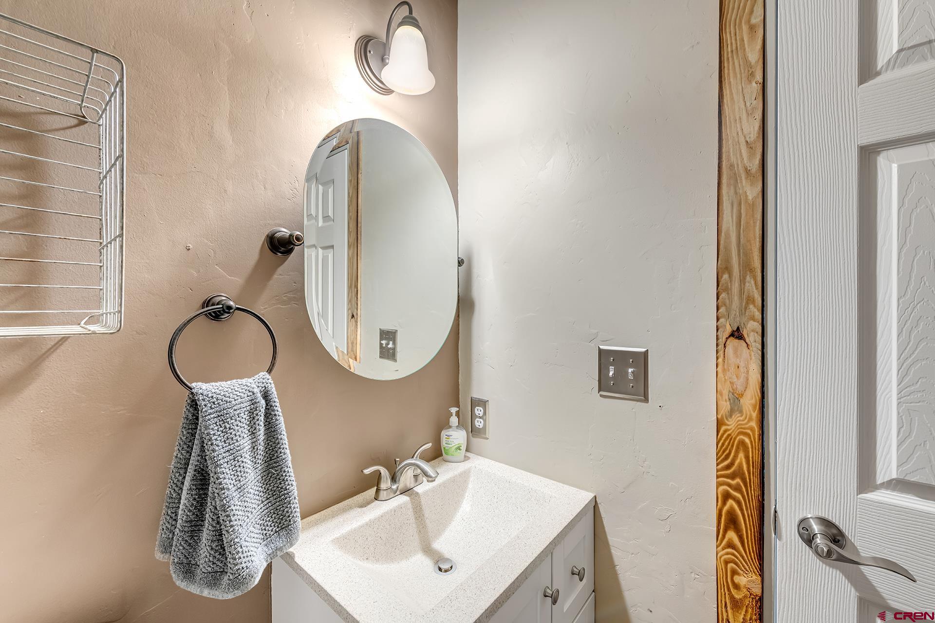 2787 2100th Road Delta, CO 81416 - Photo 30 of 40 a bathroom with a sink a mirror and a shower